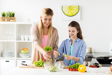 Image showing happy family cooking salad at home kitchen
