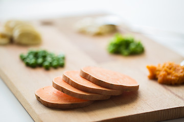 Image showing sliced pumpkin on wooden board