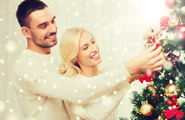 Image showing happy couple decorating christmas tree at home