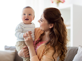 Image showing happy young mother with little baby at home