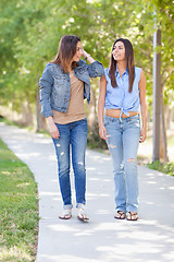 Image showing Two Beautiful Ethnic Twin Sisters Walking Outdoors.