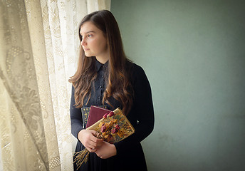 Image showing Young girl in black vintage dress