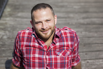 Image showing bearded handsome man relaxing outdoors in the sun