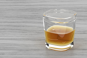 Image showing Glass of whisky on wood background