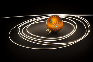 Image showing an orange christmas ball with light streaks
