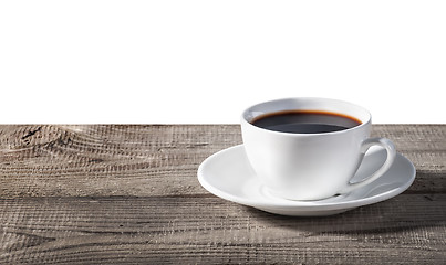 Image showing Cup of coffee on a wooden table