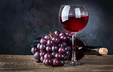 Image showing Glass wine with grapes and bottle