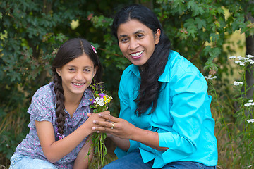 Image showing Daughter gives flowers to her mother