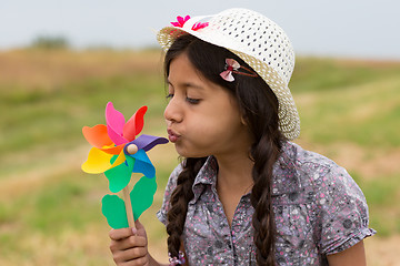 Image showing Smiling girl with pinwheel