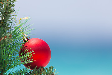 Image showing Christmas bauble on a tree with beach background