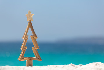 Image showing Timber Christmas tree in sand on the beach