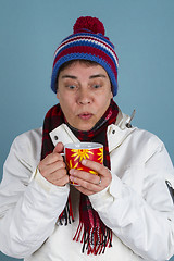 Image showing Woman drinks a cup of tea or coffee