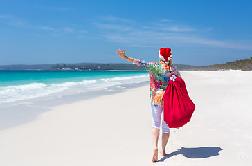 Image showing Christmas in Australia - festive woman walking along idyllic bea