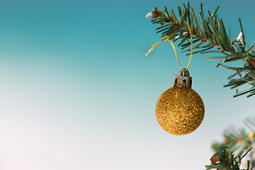 Image showing Gold glitter bauble on Christmas tree