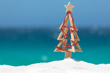 Image showing Driftwood Christmas tree decorated with string of red baubles at