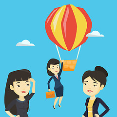 Image showing Business woman hanging on balloon.