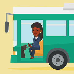 Image showing African bus driver sitting at steering wheel.