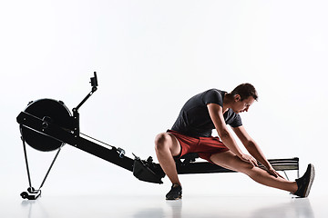 Image showing Man Using A Press Machine In A Fitness Club.