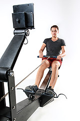 Image showing Man Using A Press Machine In A Fitness Club.