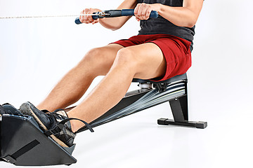 Image showing Man Using A Press Machine In A Fitness Club.