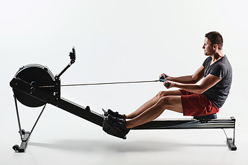 Image showing Man Using A Press Machine In A Fitness Club.