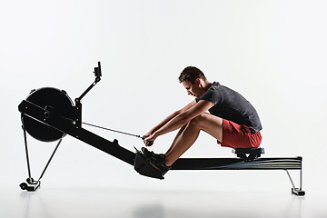 Image showing Man Using A Press Machine In A Fitness Club.