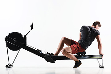 Image showing Man Using A Press Machine In A Fitness Club.