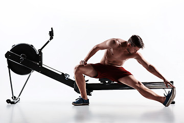 Image showing Man Using A Press Machine In A Fitness Club.