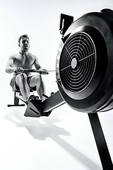 Image showing Man Using A Press Machine In A Fitness Club.