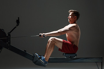 Image showing Man Using A Press Machine In A Fitness Club.