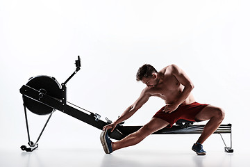 Image showing Man Using A Press Machine In A Fitness Club.