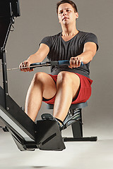 Image showing Man Using A Press Machine In A Fitness Club.