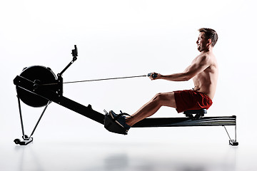 Image showing Man Using A Press Machine In A Fitness Club.