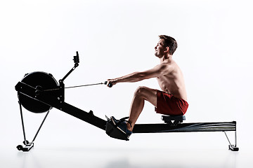 Image showing Man Using A Press Machine In A Fitness Club.