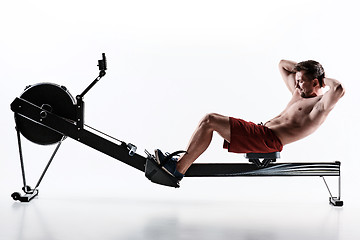 Image showing Man Using A Press Machine In A Fitness Club.