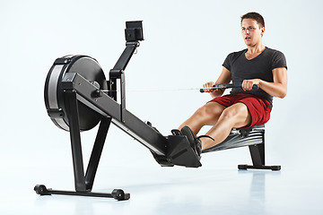 Image showing Man Using A Press Machine In A Fitness Club.