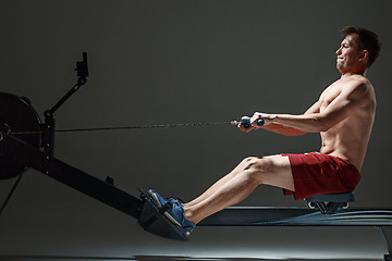 Image showing Man Using A Press Machine In A Fitness Club.