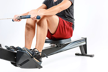 Image showing Man Using A Press Machine In A Fitness Club.