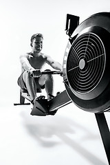 Image showing Man Using A Press Machine In A Fitness Club.