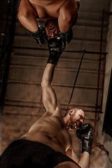 Image showing Two muscular men fighting, bodybuilders punching each other, training in martial arts, boxing, jiu jitsu