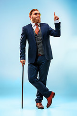 Image showing The barded man in a suit holding cane.