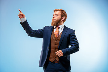 Image showing Portrait of a business man isolated on blue background.