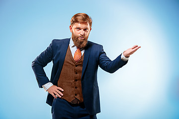 Image showing Portrait of a business man isolated on blue background.