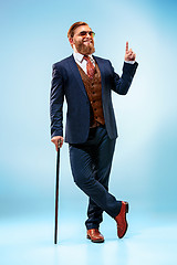 Image showing The barded man in a suit holding cane.