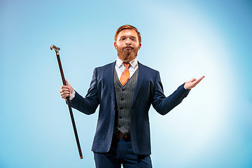 Image showing The barded man in a suit holding cane.