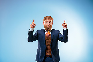 Image showing Portrait of a business man isolated on blue background.