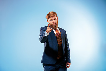 Image showing Portrait of a business man isolated on blue background.