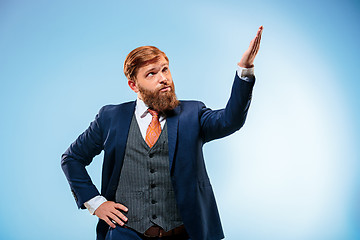 Image showing Portrait of a business man isolated on blue background.