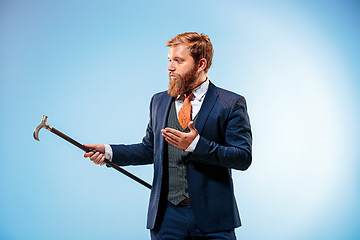 Image showing The barded man in a suit holding cane.