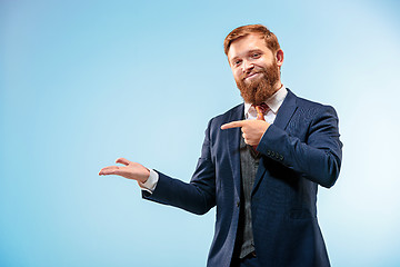 Image showing Portrait of a business man isolated on blue background.